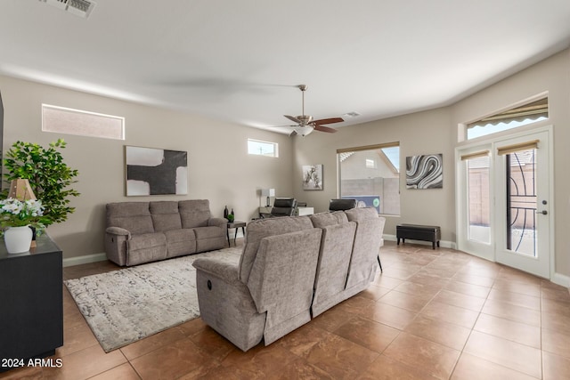 living room with tile patterned floors and ceiling fan