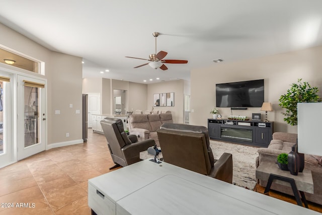 tiled living room with ceiling fan