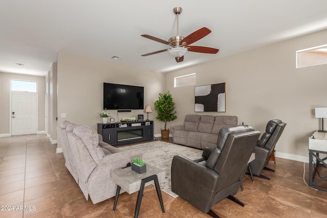 tiled living room featuring ceiling fan