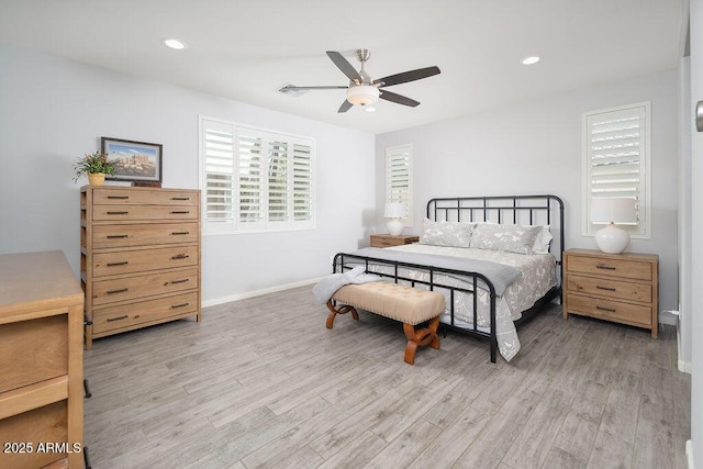 bedroom featuring light wood-type flooring, multiple windows, and recessed lighting