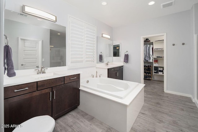 full bath with a sink, visible vents, and a shower stall