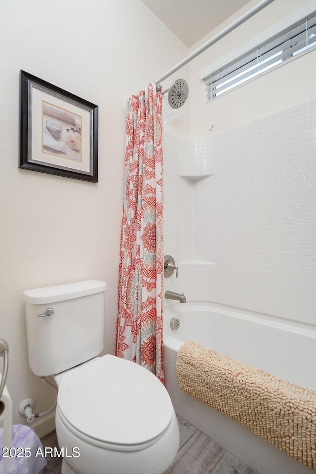 bathroom with toilet and shower / bath combo