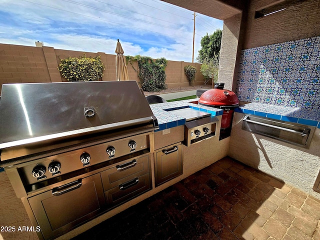 view of patio featuring area for grilling, a fenced backyard, and a grill