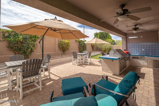 view of patio / terrace featuring outdoor dining area, a fenced backyard, area for grilling, a ceiling fan, and grilling area