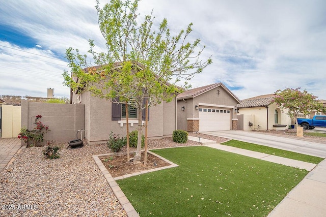 view of front of house featuring concrete driveway, stucco siding, a tile roof, an attached garage, and a front yard