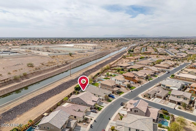 drone / aerial view featuring a residential view and a water view