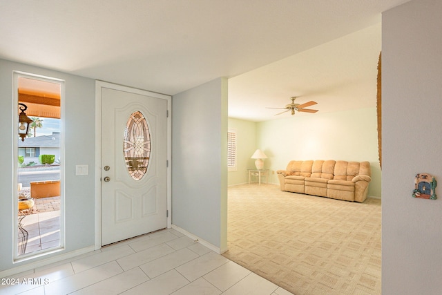 entrance foyer featuring light tile patterned floors and ceiling fan