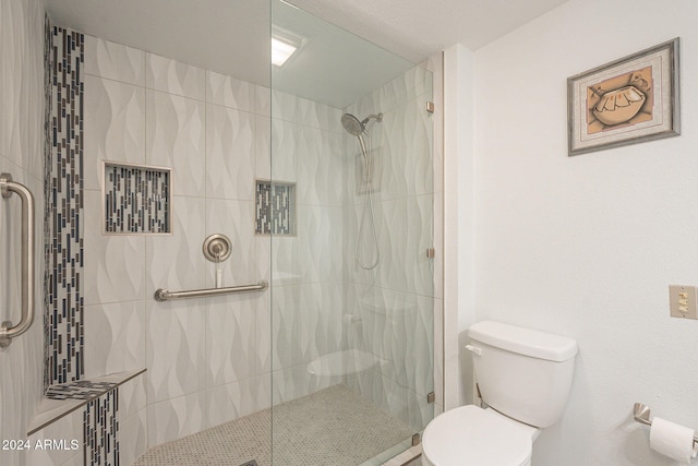 bathroom with toilet and an enclosed shower