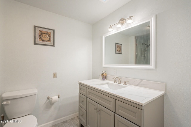 bathroom with vanity, toilet, and walk in shower