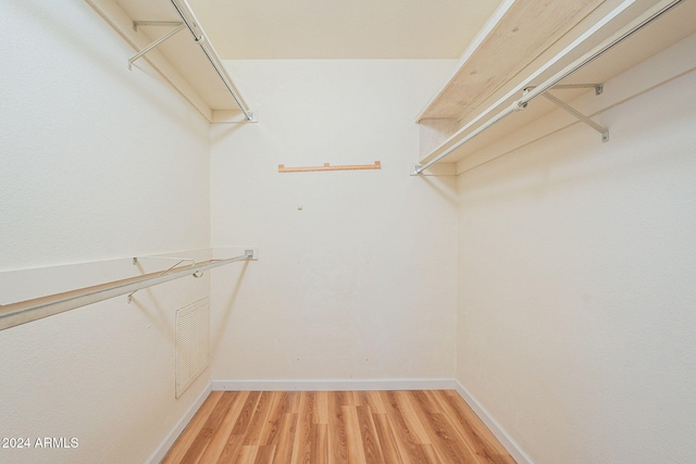 walk in closet featuring light hardwood / wood-style flooring