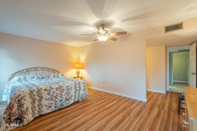 bedroom with light hardwood / wood-style floors and ceiling fan