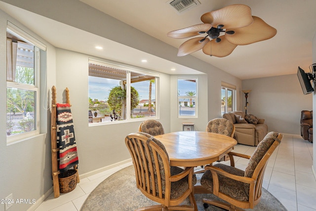 tiled dining space featuring ceiling fan and a wealth of natural light