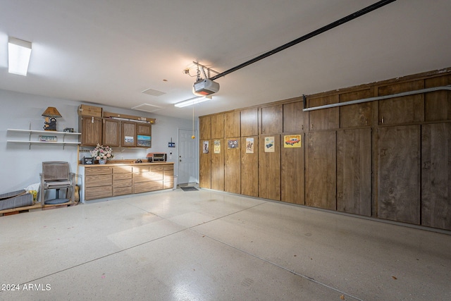 garage with a garage door opener and a workshop area