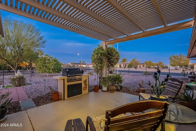 view of patio / terrace featuring a pergola, area for grilling, and an outdoor kitchen