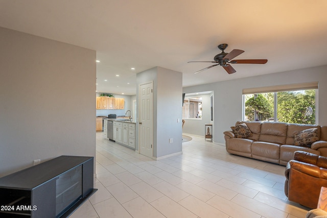 tiled living room with sink and ceiling fan