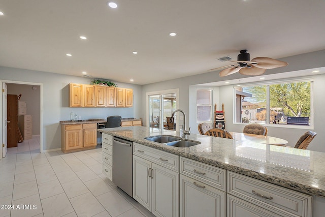 kitchen with dishwasher, light brown cabinets, sink, light stone counters, and ceiling fan