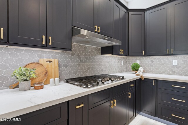 3202 E Orange Dr, Phoenix, AZ 85018 - kitchen featuring under cabinet range hood, stainless steel gas stovetop, backsplash, and light stone countertops