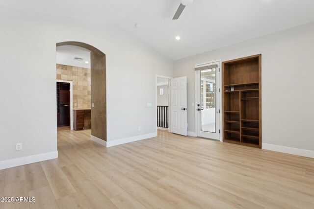 3202 E Orange Dr, Phoenix, AZ 85018 - unfurnished bedroom featuring arched walkways, light wood-style flooring, baseboards, vaulted ceiling, and access to exterior