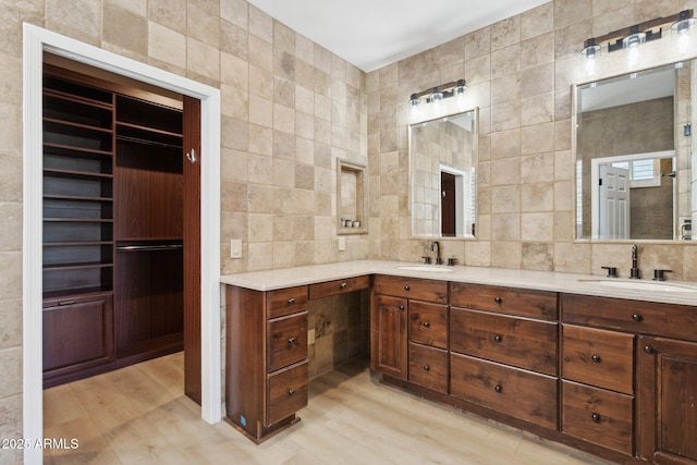 3202 E Orange Dr, Phoenix, AZ 85018 - full bath with double vanity, wood finished floors, tile walls, and tasteful backsplash