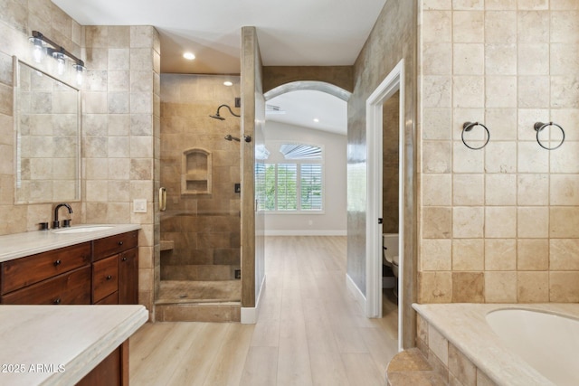 3202 E Orange Dr, Phoenix, AZ 85018 - bathroom featuring vanity, wood finished floors, a shower stall, a garden tub, and recessed lighting