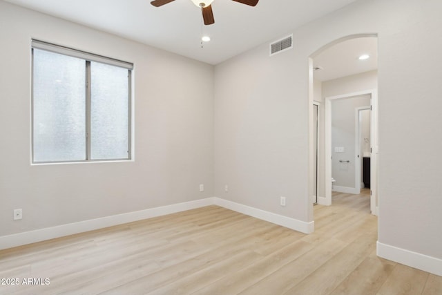 3202 E Orange Dr, Phoenix, AZ 85018 - empty room featuring ceiling fan, arched walkways, wood finished floors, baseboards, and recessed lighting