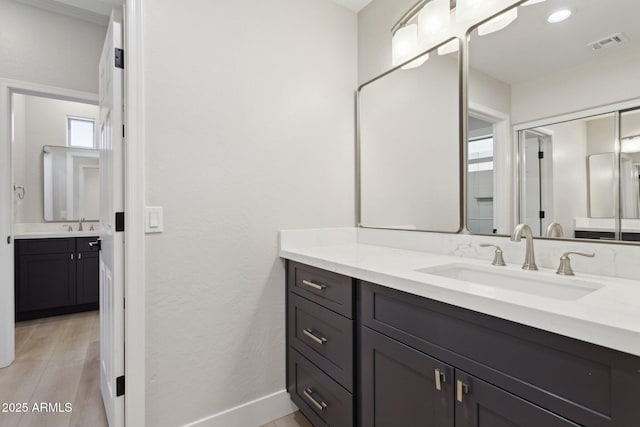 3202 E Orange Dr, Phoenix, AZ 85018 - bathroom featuring vanity, baseboards, and wood finished floors