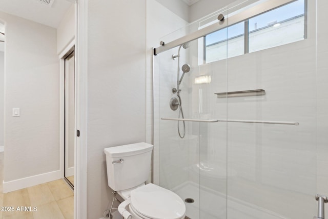 3202 E Orange Dr, Phoenix, AZ 85018 - bathroom with a stall shower, toilet, wood finished floors, and baseboards