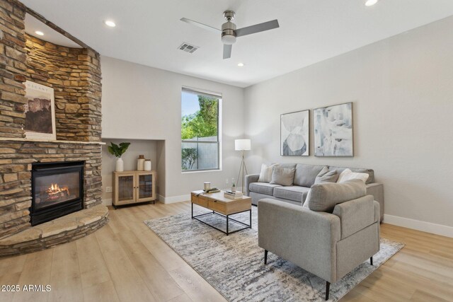 3202 E Orange Dr, Phoenix, AZ 85018 - living area with a stone fireplace, a ceiling fan, wood finished floors, baseboards, and recessed lighting