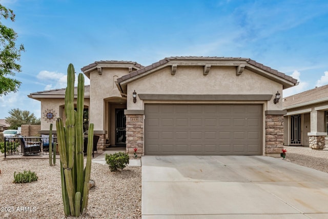 mediterranean / spanish-style home with stucco siding, stone siding, and an attached garage