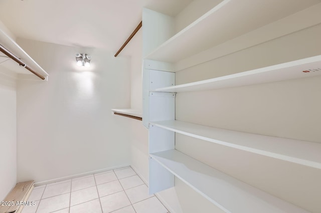 walk in closet featuring light tile patterned flooring