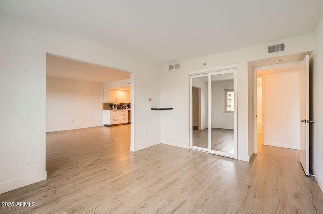 spare room featuring light wood-type flooring