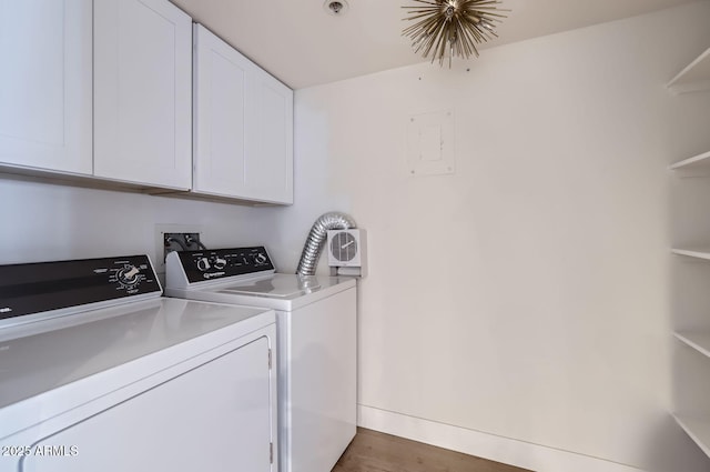 washroom featuring separate washer and dryer, dark hardwood / wood-style floors, and cabinets