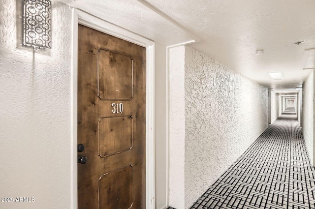 hallway with a textured ceiling