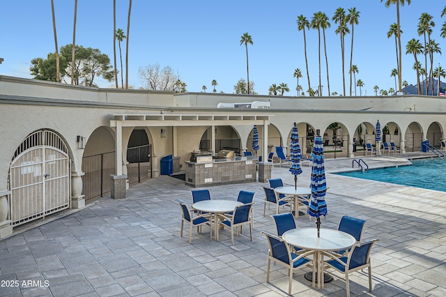 view of patio / terrace featuring exterior kitchen and a community pool