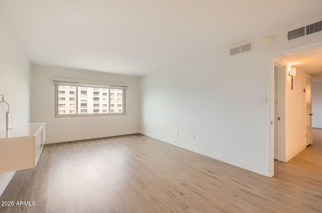 unfurnished room with light wood-type flooring