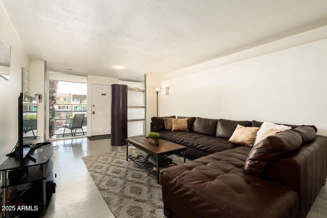 living area featuring a textured ceiling and speckled floor