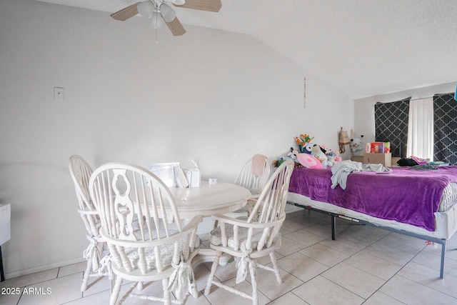 interior space featuring light tile patterned floors, baseboards, and lofted ceiling