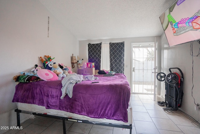 tiled bedroom with lofted ceiling, a textured ceiling, and access to exterior