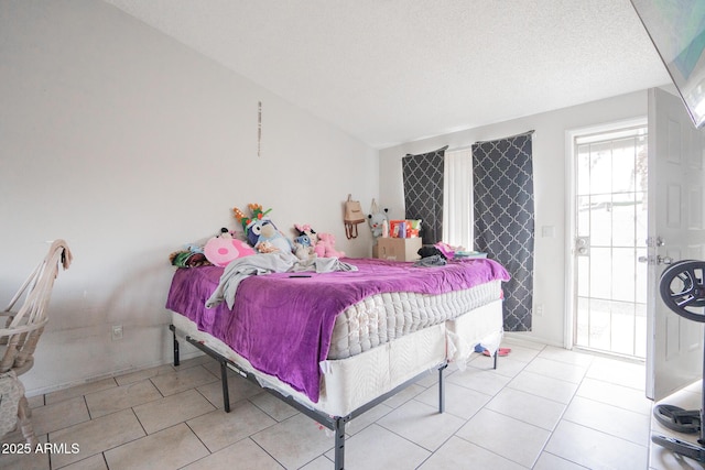 bedroom with light tile patterned flooring and a textured ceiling