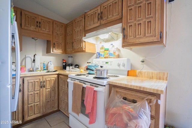 kitchen with light tile patterned floors, white electric stove, a sink, light countertops, and under cabinet range hood