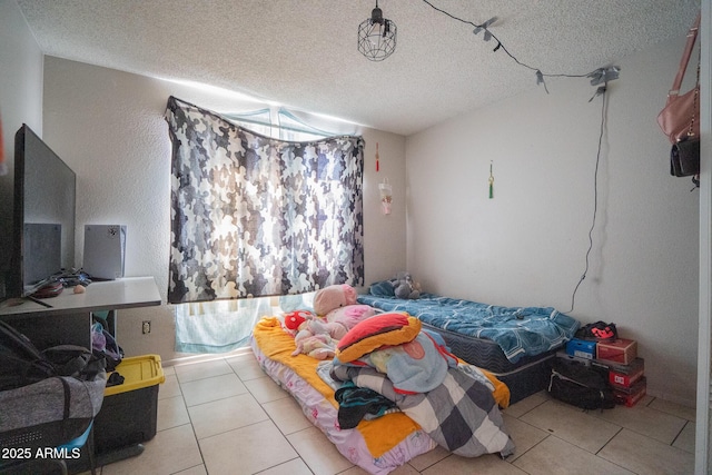 tiled bedroom with a textured ceiling