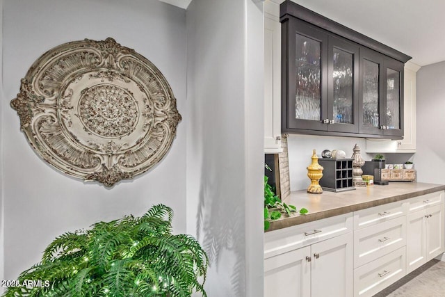 bar with dark brown cabinets and white cabinetry