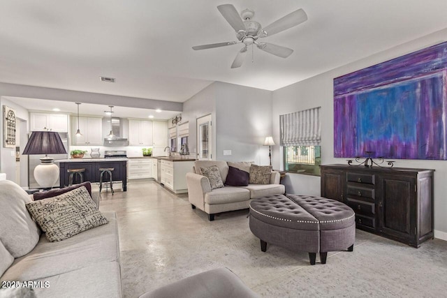 living room with ceiling fan and sink