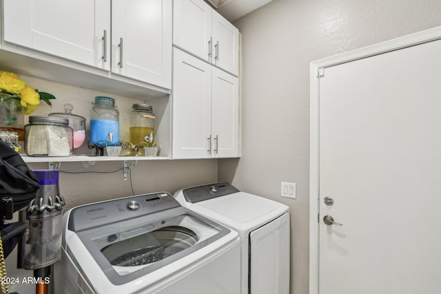 clothes washing area with cabinets and washer and dryer