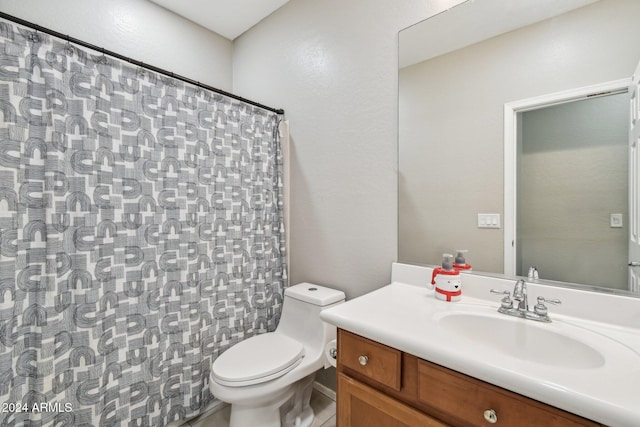 bathroom featuring vanity, toilet, and walk in shower