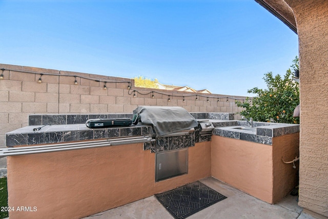 view of patio / terrace featuring a grill, area for grilling, and sink