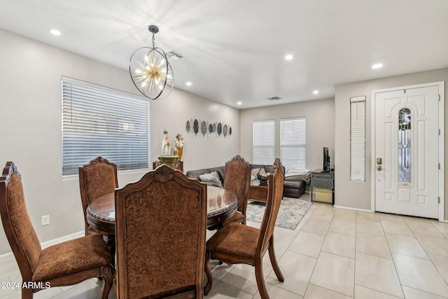 dining space with light tile patterned flooring and a chandelier