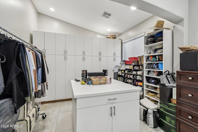 spacious closet with light tile patterned floors and vaulted ceiling