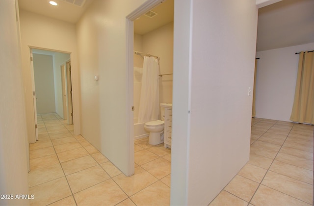 corridor with light tile patterned floors