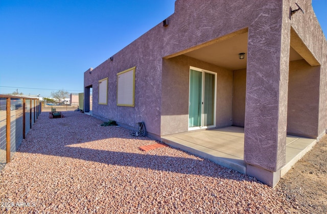 view of side of property with a patio